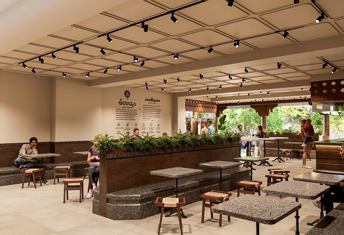 The dining hall under its coffered ceiling, planted dividers running between the granite tables